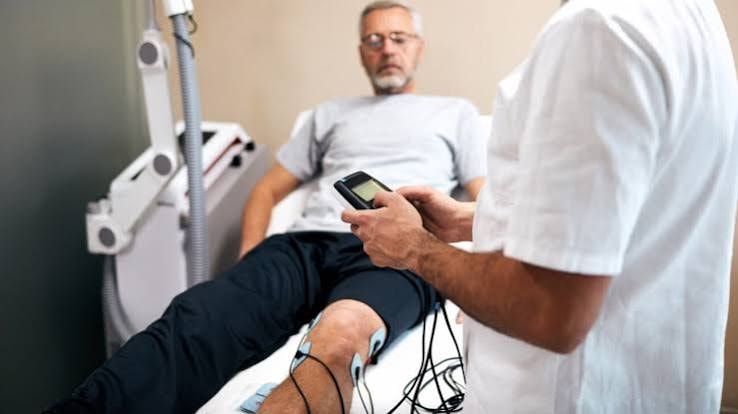 Physiotherapist using palms to measure rib cage expansion during breathing assessment