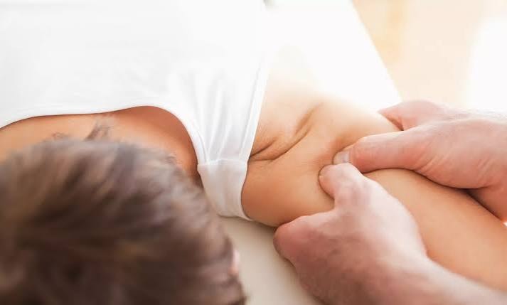 Thai massage tools — wooden stick and herbal compress ball